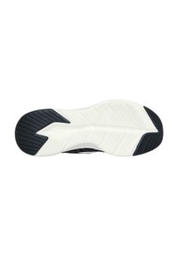 Suela exterior de zapato deportivo negro con una sección central blanca texturizada y áreas de agarre de goma negra, presentando un patrón distintivo de zigzag.