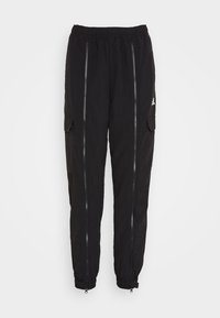 Svarta cargobyxor med elastisk midja, texturerad tyg, två sidogenära dragkedjor och dragkedjor vid bensluten. Har en sidoficka och diskret branding.