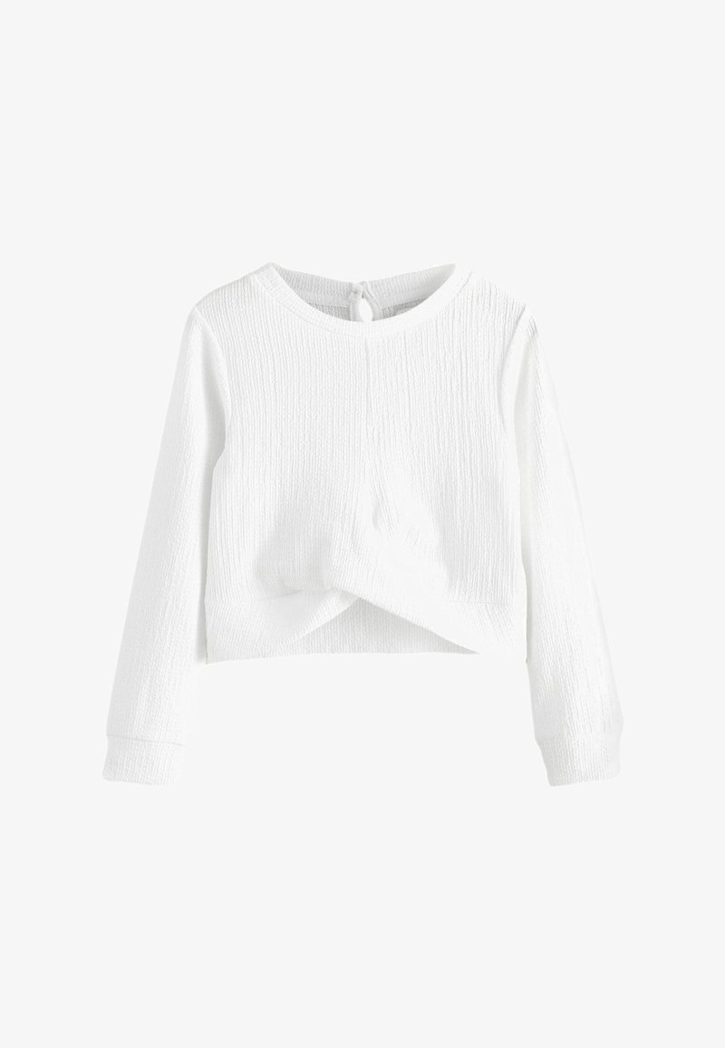 Biely dlhý rukáv crop top v textúrovanej látke s okrúhlym výstrihom a uzlom vpredu. Obsahuje zapínanie na gombík na zadnej strane.