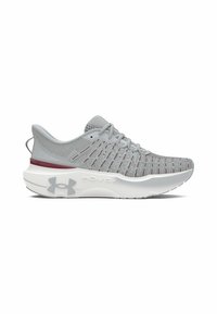 Zapatilla deportiva gris claro con una parte superior de malla transpirable y detalles en rojo, suela blanca acolchada y el logotipo "HOVR+" en el costado.