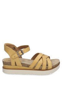 Żółte skórzane sandały z krzyżującymi się paskami, paskiem na kostkę z metalowym klamrem, korkową podeszwą środkową i białą gumową podeszwą zewnętrzną. Lekka konstrukcja.