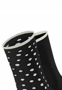 Schwarze Socken mit strukturiertem Rippdesign, akzentuiert durch unregelmäßige weiße Punkte und einem kontrastierenden weißen Bündchen am Öffnung.