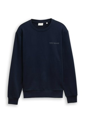 Temno modra majica iz bombažnega mešanice z ovratnikom okrogel izrez in dolgimi rokavi. Ima majhen bel napis logotipa na prsih.