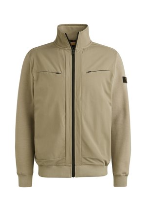 Beige zip-up jacket with high collar, two zippered chest pockets, ribbed cuffs, and a smooth texture throughout. Features contrasting dark zippers.