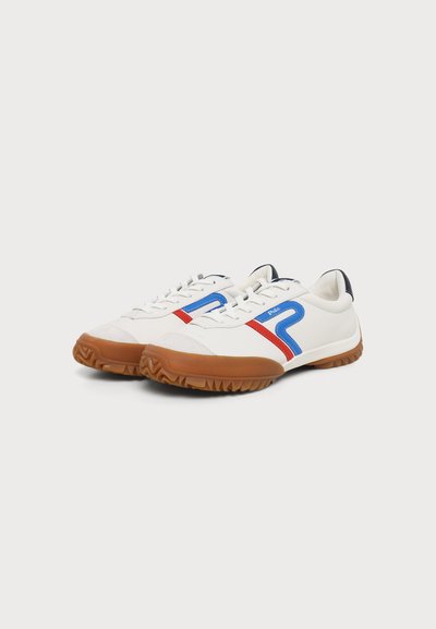 Λευκά sneakers χαμηλού πάτου με μπλε και κόκκινες πλευρικές ρίγες, καφέ υφασμάτινες σόλες και λευκά κορδόνια σε απλό ανοιχτό φόντο.
