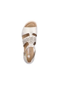 Light metallic silver sandal with cut-out geometric design, adjustable strap, soft footbed, and white sole. Features logo on insole.
