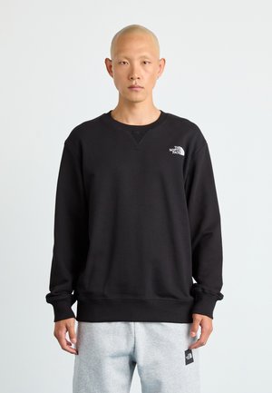 Zwarte sweatshirt van een katoenmix, met een ronde halslijn, geribbelde manchetten en een klein wit logo op de bovenste linkerborst.