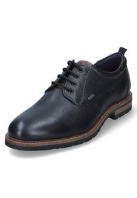 Chaussure en cuir noir à lacets avec une finition lisse, bout arrondi, semelle en caoutchouc durable et un petit logo sur le côté. Accent marron sur la semelle.