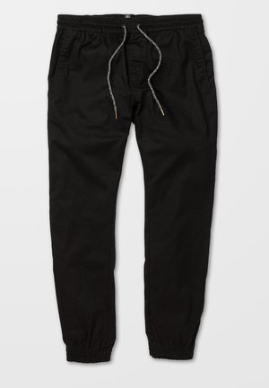 Pantaloni jogger neri con vita elasticizzata, cordino con punte in metallo, tasche laterali e polsini elasticizzati sulle gambe.