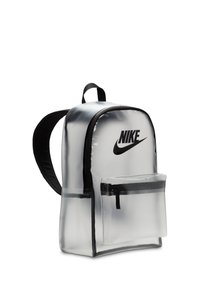 Gjennomsiktig PVC ryggsekk med svarte detaljer, som har en frontlomme med glidelås, buet topp og justerbare svarte stropper. Nike-logoen vises på en fremtredende måte.