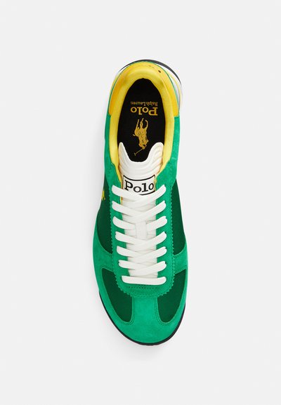 Green suede sneaker with white laces, yellow inner lining, mesh accents, and a black outsole. Features a "Polo" logo on the tongue.