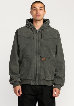 Dark grey hooded jacket made of textured fabric, featuring a front zipper, two side pockets, and elasticized cuffs and hem.