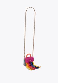Quilted handbag with orange handle, chain strap, and multicolored fringes in pink, blue, and yellow. Textured material with decorative emblem.