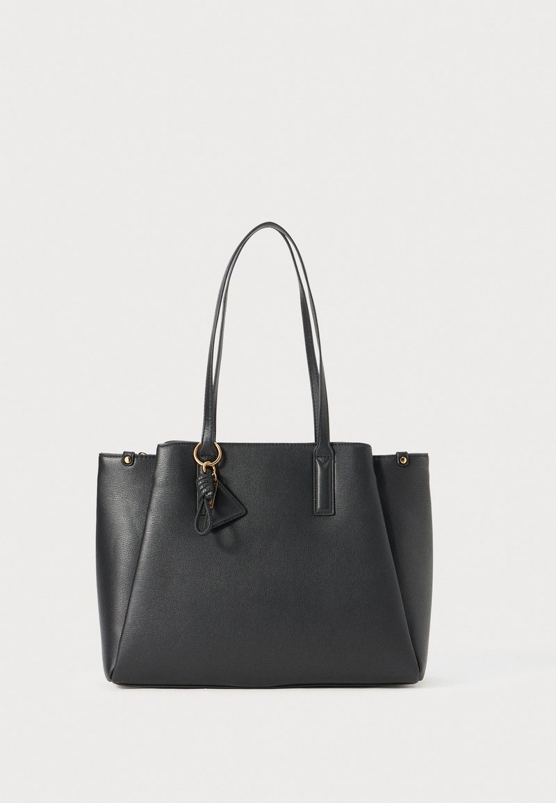 Black faux leather tote bag with dual handles, triangular charm, zipper closure, and a textured surface. Features gold-tone hardware accents.