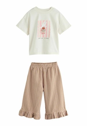Weißes Kinder-T-Shirt mit kurzen Ärmeln mit Hasengrafik und "Smile Time" Text, kombiniert mit beige-weiß gestreiften, gerafften Hosen.