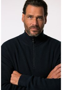 Navy-zipper Sweatshirt mit gerippter Textur, hohem Kragen und einem halblangen Reißverschluss, mit enganliegendem Bündchen und lockerer Passform.