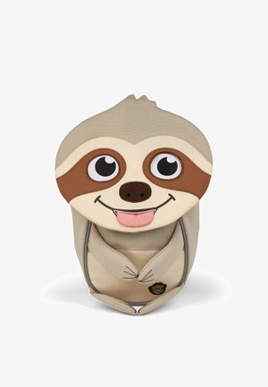 Beige and brown children's backpack shaped like a smiling sloth with large eyes and tongue sticking out, front paws clasped.