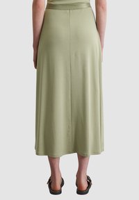 Long, A-line skirt in light green cotton blend, featuring a smooth texture, an elastic waistband, and a hem that falls below the calves.