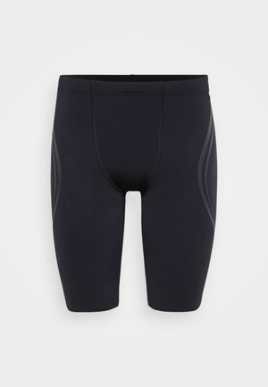 Svarta träningsshorts i elastiskt material, med en tajt passform, flatlocksömmar och texturerade detaljer på sidorna.