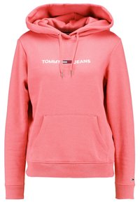 Sudadera rosa de tejido suave con un bolsillo frontal, cordones y el logo "TOMMY JEANS" con un acento a rayas en el pecho.
