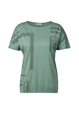 Light green T-shirt with short sleeves, featuring abstract dark gray geometric patterns and a gathered hem for a relaxed fit.
