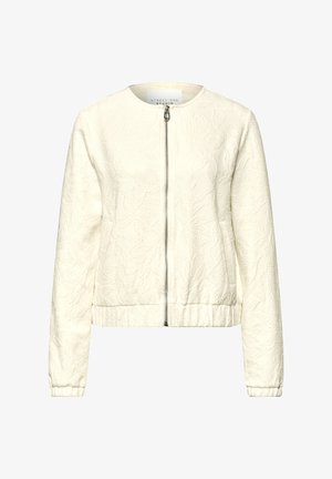 Kremowa biała damska kurtka z wypukłym kwiatowym wzorem, przednim zamkiem błyskawicznym, okrągłym dekoltem, długimi rękawami oraz elastycznym dołem i mankietami.