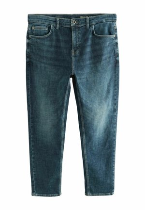 Mørkeblå denim jeans med et klassisk fem lomme-design, der har en lynlås og en let falmet tekstur på lårene.