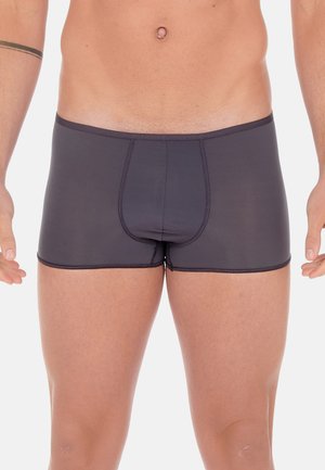 Black boxer briefs made of stretchy fabric, featuring a snug fit with a contour pouch and contrasting stitching along the edges.