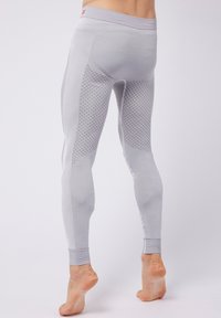 Leggings elasticizzati leggeri grigi, con accenti in tessuto a motivo diamante e pannelli laterali a costine. Vita e polsini alla caviglia elasticizzati.