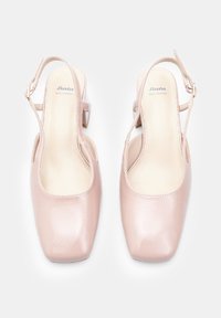 Pink leather slingback shoes with a square toe, smooth texture, and a small heel. Features an adjustable strap and branding on the insole.