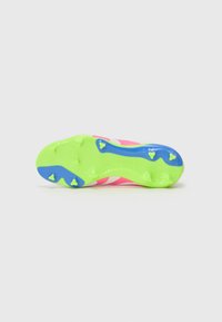 Suela de bota de fútbol de color rosa brillante con una base verde texturizada, acentos en azul y componentes de tracción con tachuelas amarillas. "PREDATOR" está grabado.