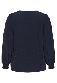 Blusa azul marino con mangas largas abullonadas, tejido texturizado y un cuello redondo. Presenta puños elásticos y un corte relajado.