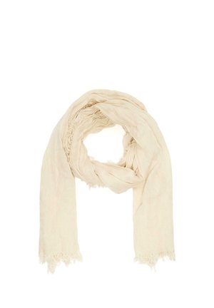 Vaaleanbeige pehmeä kangashuivi, jossa on hienovaraiset repsottavat reunat, löyhästi lenkitettyinä ja päät roikkuvat valkoista taustaa vasten.