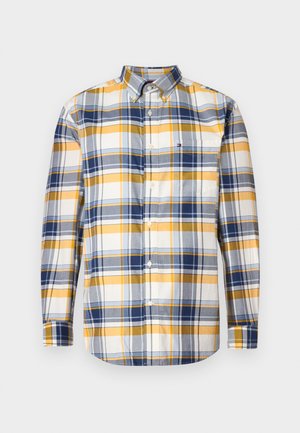 Camisa de manga larga abotonada con patrón de cuadro amarillo, azul y blanco, y un bolsillo en el pecho delantero que presenta un pequeño logo.