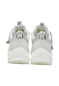 White vegan sneakers with smooth material, chunky sole, and reflective accents. Features a pull tab and chain detail on the heel.