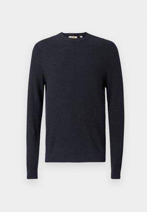 Maglione blu navy a coste con scollo rotondo, maniche lunghe e tessuto testurizzato. Presenta un orlo e polsini aderenti.