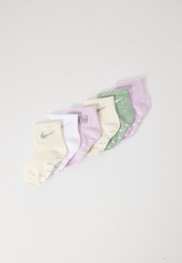 Hat kis zokni szett világos színekben: krém, fehér, levendula és zöld. Mindegyik ribbed mandzsettával és kontrasztos színű márkázással rendelkezik.