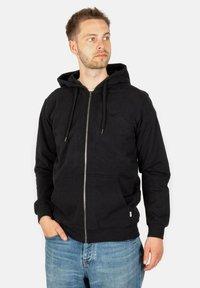 Schwarze Zip-Hoodie mit Kordelzugkapuze, Fronttaschen und dezentem Logo. Hergestellt aus weichem Stoff mit gerippten Bündchen und Saum.