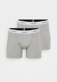 Boxeri din bumbac gri, cu un tiv elastic alb și negru, având textul "carhartt". Două perechi expuse. Material moale, design ajustat.