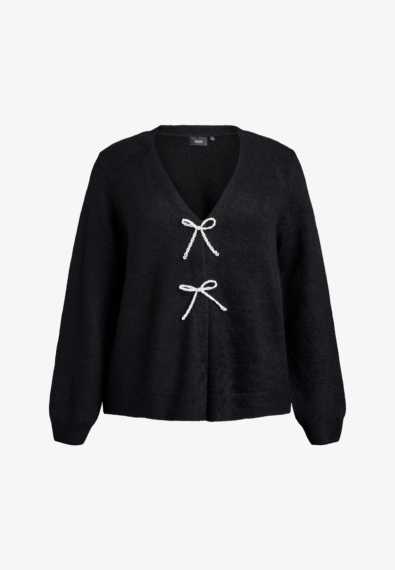 Maglione nero a maglia con scollatura a V profonda, maniche lunghe e due fiocchi bianchi sul petto. Morbido al tatto con orlo a coste.