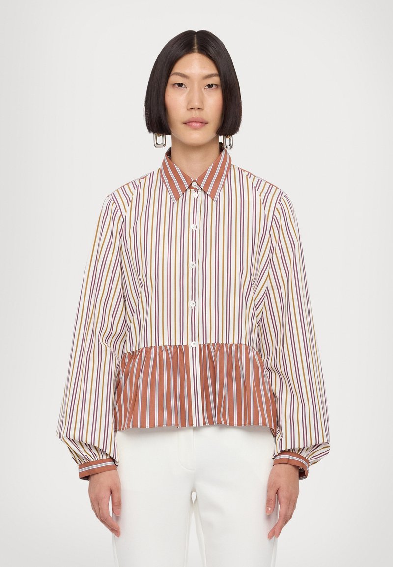 Striped button-up shirt with a peplum hem. Features a mix of colors including brown, yellow, and purple. Long, puffed sleeves with contrasting cuffs.