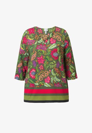 Vihreä kukallinen tunika 3/4-hihalla, jossa on värikkäitä kukkia vaaleanpunaisena, punaisena ja sinisenä, ja punainen vaakaraita helman kohdalla.