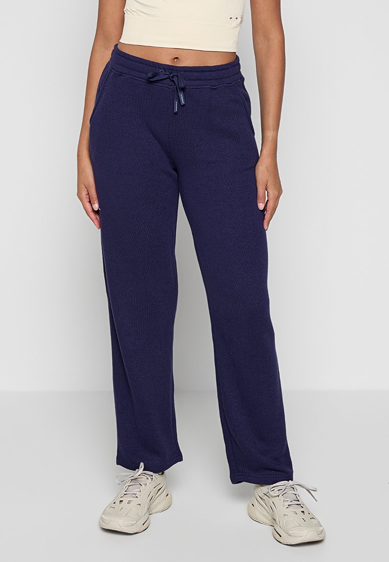 Pantalons de survêtement bleu marine en tissu texturé, avec une taille élastique dotée d'un cordon de serrage et une coupe droite.