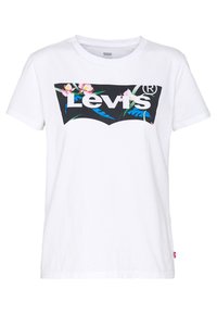 Valkoinen puuvillapaita, jossa on musta grafiikka "Levi's"-logolla, jota korostavat kukka- ja lehtimuotit vaaleanpunaisena ja sinisenä.