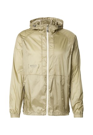 Jasna khaki kurtka z kapturem wykonana z błyszczącego, lekkiego materiału; posiada zamek błyskawiczny z przodu, elastyczne mankiety oraz wypukłe logo na piersi.