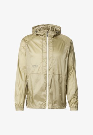 Jasna khaki kurtka z kapturem wykonana z błyszczącego, lekkiego materiału; posiada zamek błyskawiczny z przodu, elastyczne mankiety oraz wypukłe logo na piersi.