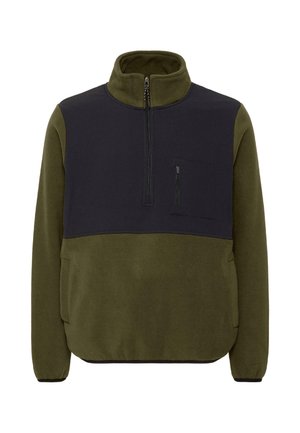 Siltinā sausais krēklis olīvzaļā un tumši zilā krāsā, ar augstu apkakli, pusvetriņu un krūšu kabatu. Strukturēta auduma un elastīgi aproces.