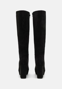 Stivali alti in suede neri con tacco spesso, caratterizzati da una texture liscia e una cerniera laterale per una vestibilità facile.