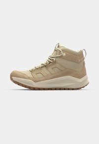 Beige High-Top-Wanderschuhe aus Wildleder und Stoff, ausgestattet mit einer Gummisohle, einem Schnürsystem und einem gepolsterten Kragen.
