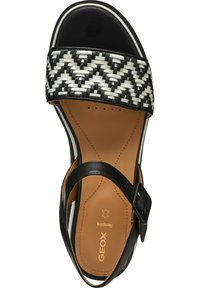 Sandal in pelle intrecciata bianco e nero con una larga fascia, soletta in pelle, cinturino alla caviglia regolabile e un elegante coprisedile nero.